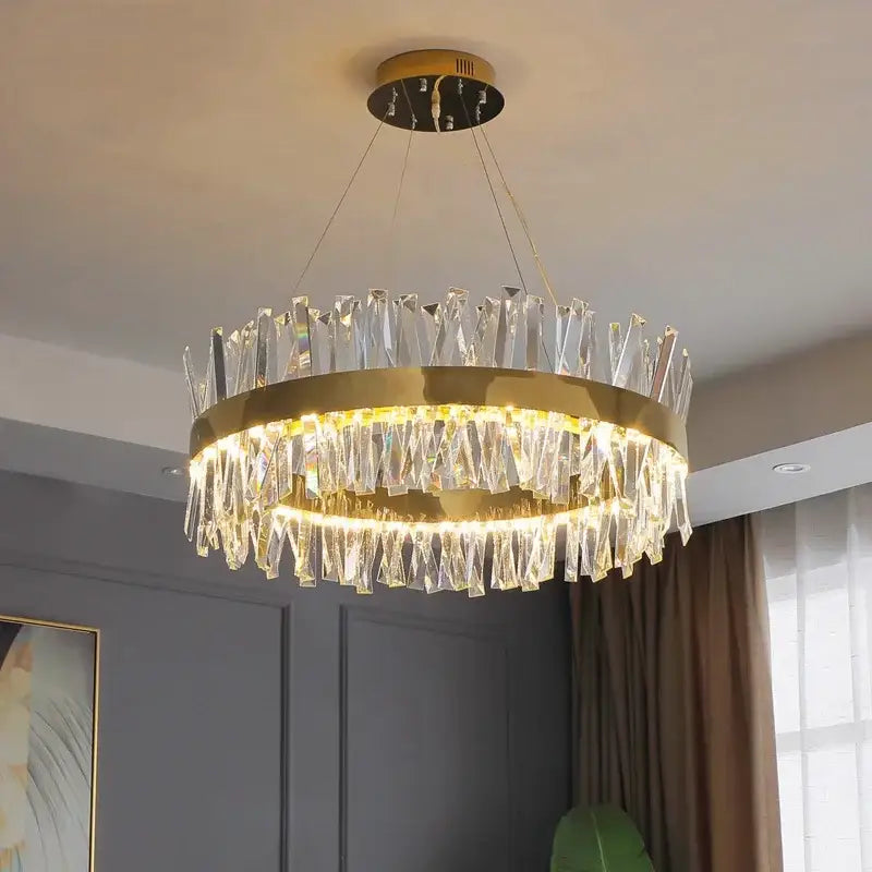 Decorbites crystal chandelier with gold-toned metal frame and clear crystal prisms for modern living room lighting