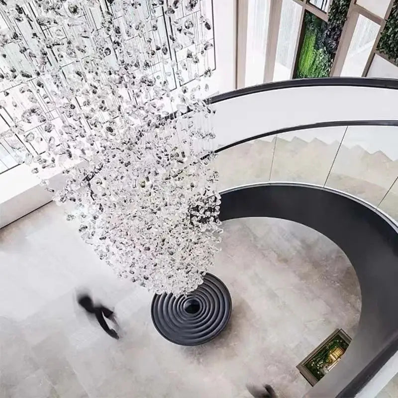 A decorbites crystal chandelier featuring clear faceted crystals and dark metal frame for staircase or lobby lighting