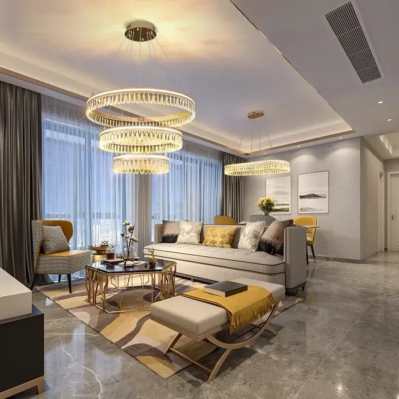 Three-tiered decorbites crystal chandelier with modern circular design and warm golden LED lighting for luxurious spaces
