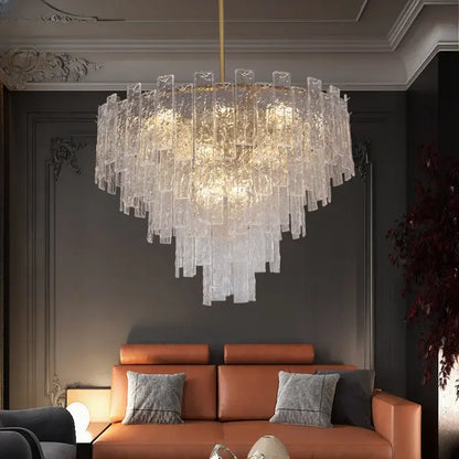 A modern decorbites crystal chandelier with cascading textured glass panels and gold-toned rod for home decor lighting