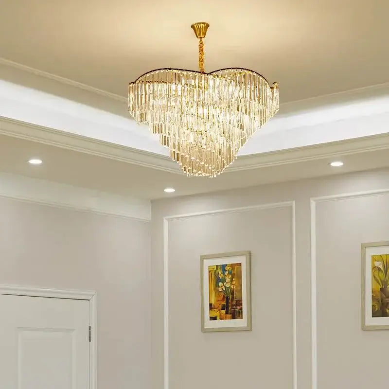 A heart-shaped decorbites crystal chandelier with cascading crystal strands and gold-toned metal frame for modern spaces