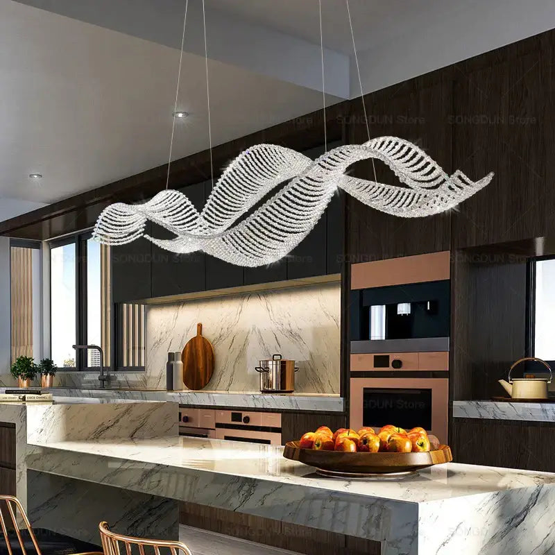 A modern silver-toned decorbites crystal chandelier with a flowing wave design for luxury dining and bar lighting