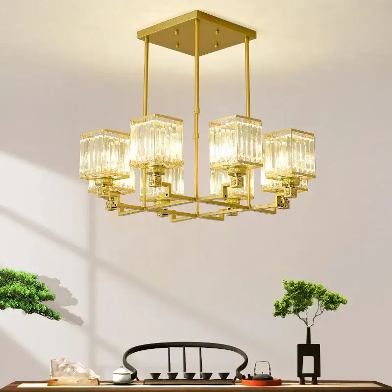 Gold-toned decorbites crystal chandelier with clear ribbed glass cubes suspended from a square frame for luxury lighting