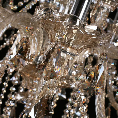 A decorbites crystal chandelier with faceted amber and clear glass elements on a polished chrome fixture for bedroom lighting