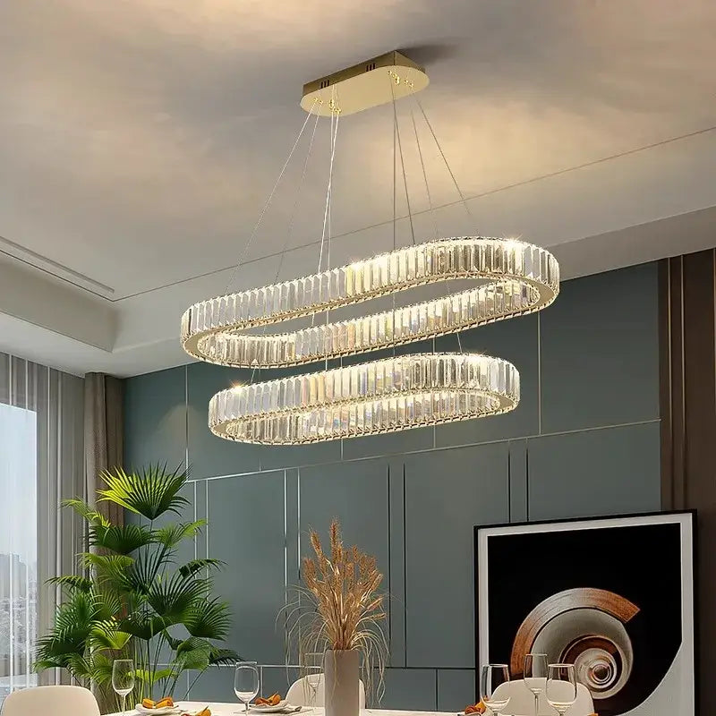 Modern decorbites crystal chandelier with clear crystal prisms and gold-toned ceiling mount for living and dining rooms