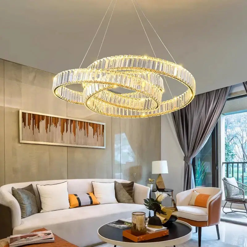 A modern decorbites crystal chandelier with multi-tiered golden rings and clear faceted crystals for living and dining rooms