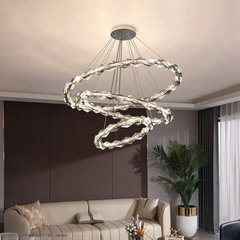 A modern decorbites crystal chandelier with multi-tiered interlocking crystal rings for duplex staircase lighting