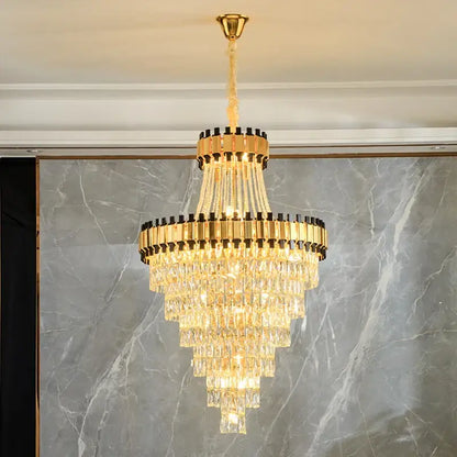 Golden tiered decorbites crystal chandelier with cascading crystal prisms and black accents for luxury venues