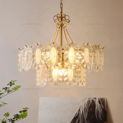 A decorbites crystal chandelier with clear crystal petals and gold-toned metal accents for modern luxury living rooms and bedrooms