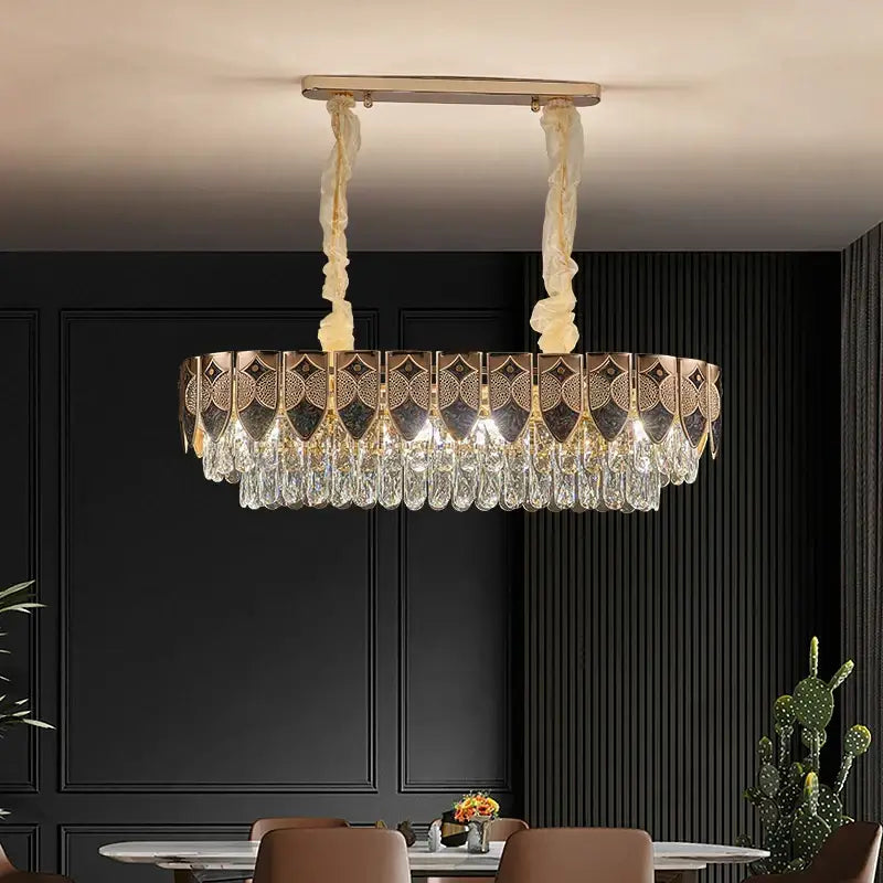 A decorbites crystal chandelier featuring intricate gold-toned metalwork and cascading clear crystals for modern luxury