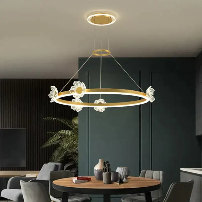 Gold-toned decorbites crystal chandelier with clear flower-shaped crystal accents for modern luxury lighting