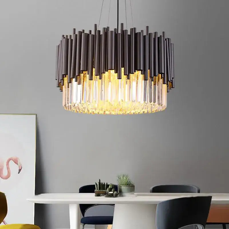 Modern black metal decorbites crystal chandelier with cascading crystal prisms emitting warm golden light for elegant rooms