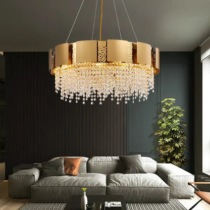 Gold-toned DecorBites crystal chandelier with circular frame and cascading crystal droplets for modern luxury lighting