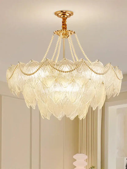 Elegant gold-toned decorbites crystal chandelier with layered translucent glass leaf shades and delicate beaded chains for luxury lighting