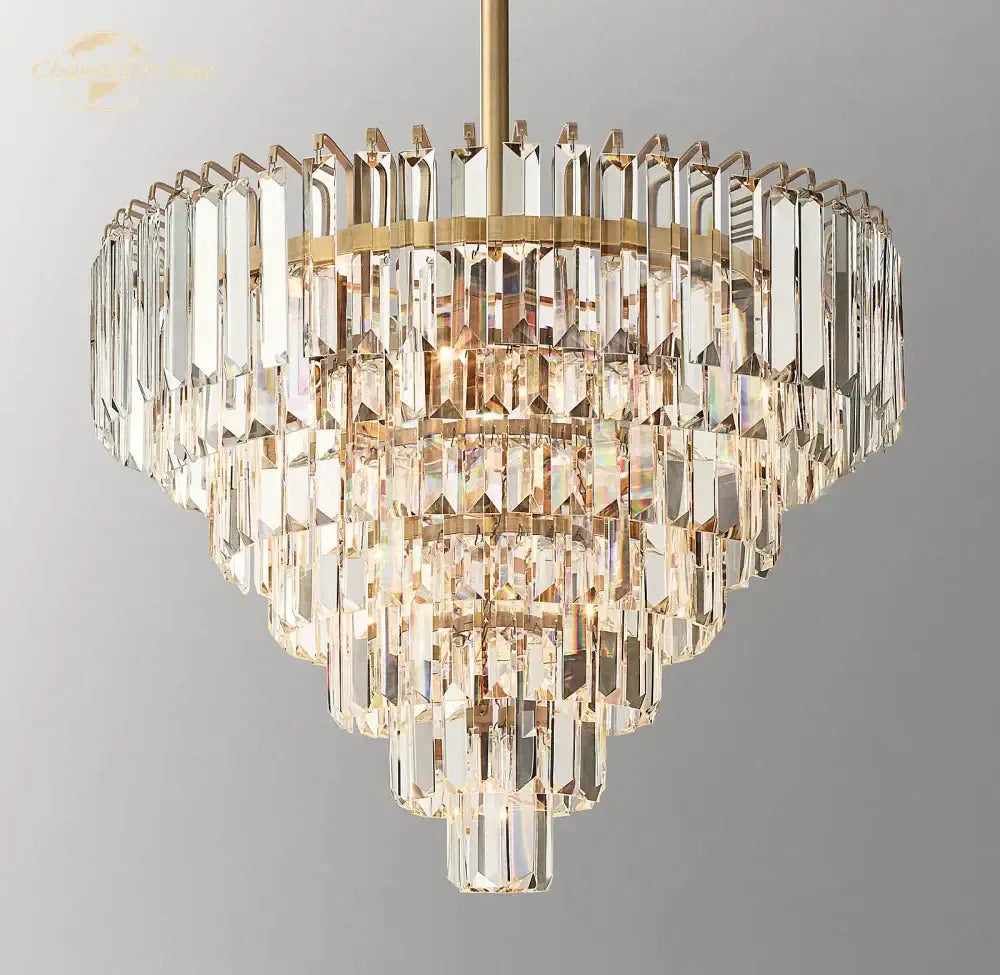 A decorbites crystal chandelier with a gold-toned frame and cascading prisms for modern dining room lighting