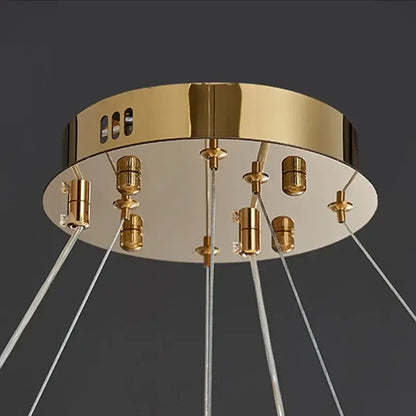 Gold-toned decorbites crystal chandelier pendant lamp with clear glass cords and metallic sockets for elegant home lighting