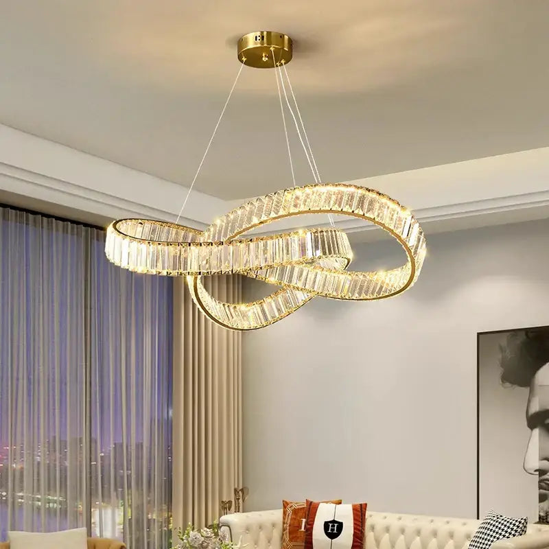 Gold-toned decorbites crystal chandelier pendant lamp with infinity loop design and faceted crystal accents for modern home lighting