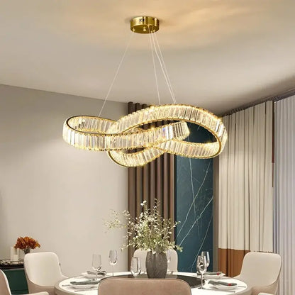Gold-toned infinity loop chandelier with faceted crystal accents.
