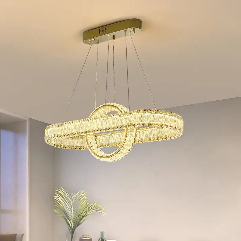 Gold-toned decorbites crystal chandelier with two interlocking rings for modern living room lighting and home decor