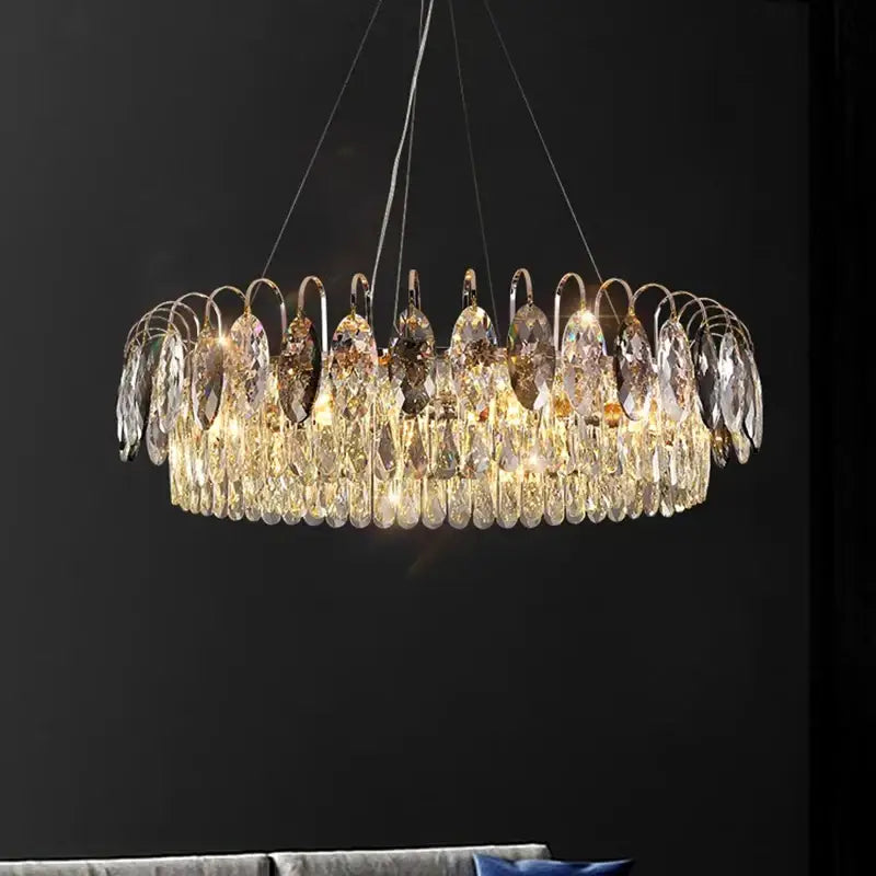 A modern decorbites crystal chandelier pendant light with cascading crystal teardrops and gold-toned frame for indoor use