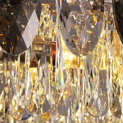 A decorbites crystal chandelier pendant light with sparkling faceted teardrop and geometric prisms catching golden light