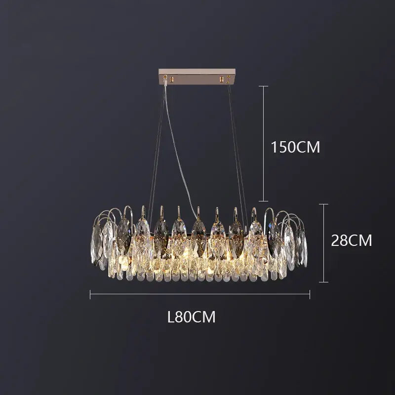 A modern circular decorbites crystal chandelier pendant light with rose gold finish and clear crystal teardrop pendants