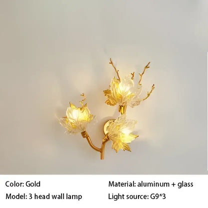 Gold-colored decorbites crystal chandelier wall lamp with three aluminum arms and delicate glass flower designs