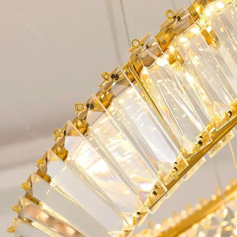 Gold-toned decorbites crystal chandelier with faceted clear crystal panels for stair and living room lighting