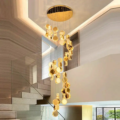 Golden circular decorbites crystal chandelier with mirrored discs hanging from a modern ceiling fixture for stair pendant lighting