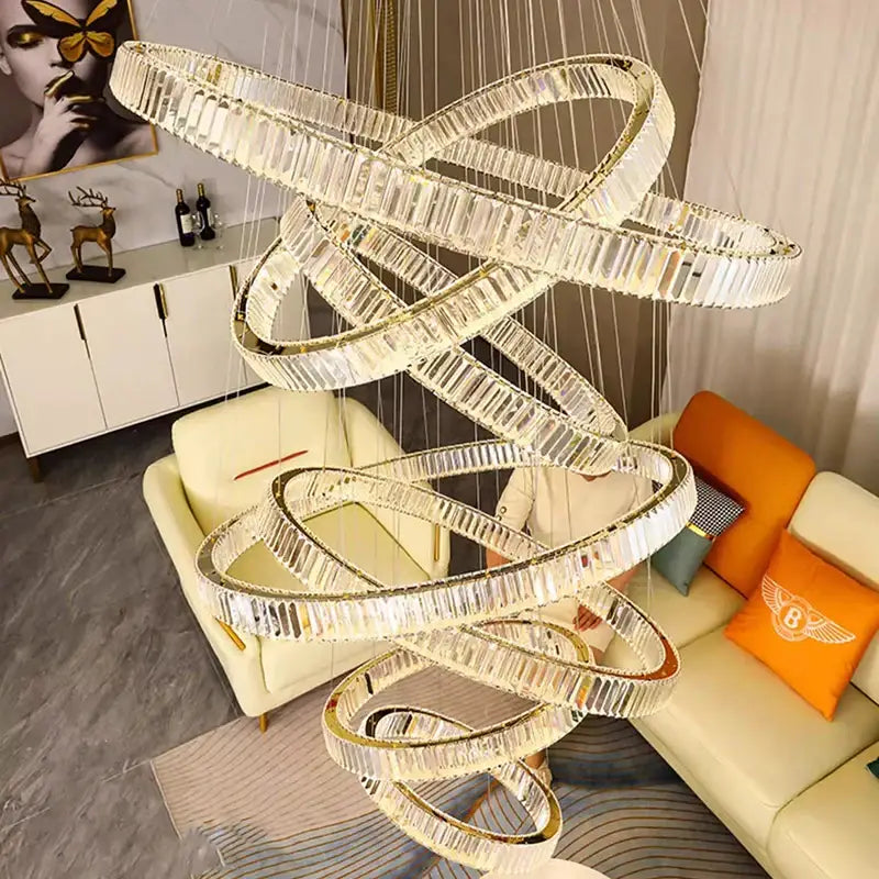 Decorbites crystal chandelier featuring multi-tiered interlocking crystal rings with gold-toned accents for living room lighting