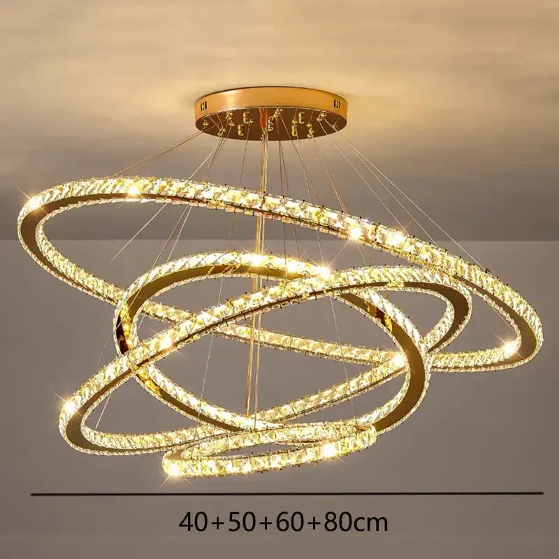 Golden ring decorbites crystal chandelier with interlocking crystal-encrusted hoops emitting warm light for living room lighting