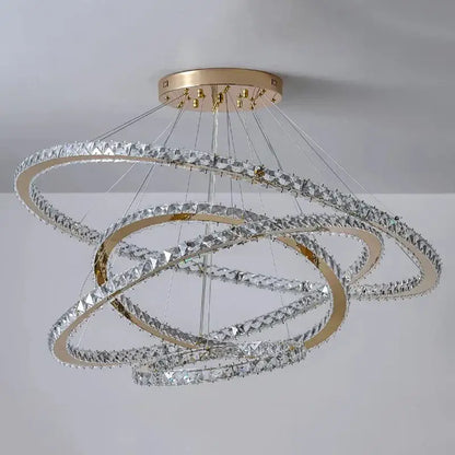 A modern decorbites crystal chandelier stair pendant light with gold-toned rings and clear crystals for interior lighting
