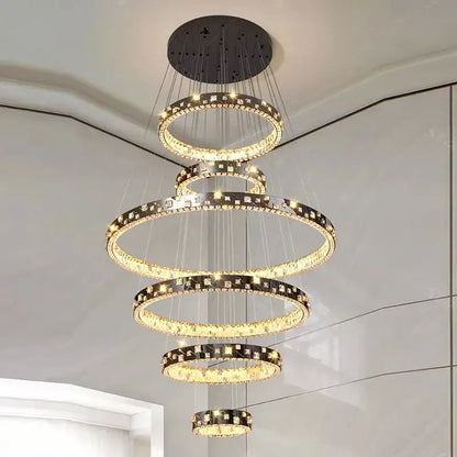 A modern decorbites crystal chandelier stair pendant lamp with cascading clear crystals and black metal accents