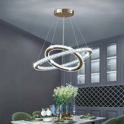 A modern gold-toned DecorBites crystal chandelier stair pendant light with two interlocking crystal rings