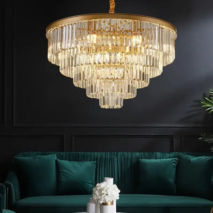 DecorBites crystal chandelier stair pendant light with gold frame and clear glass rods above green velvet sofa