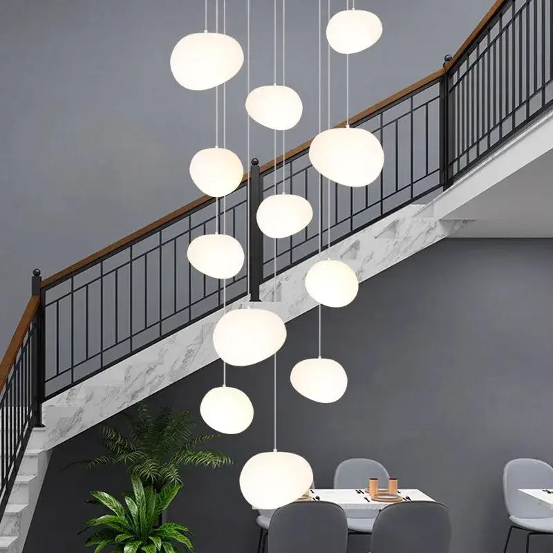 Modern white spherical pendant light from decorbites crystal chandelier stair collection hanging above dining area