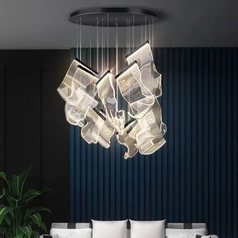 Decorbites crystal chandelier with modern acrylic pendant light featuring translucent panels emitting warm light for stair use