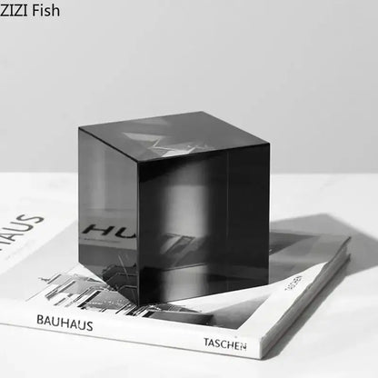 A sleek translucent black glass decorbites crystal cube with polished surface and subtle reflections for living room decor