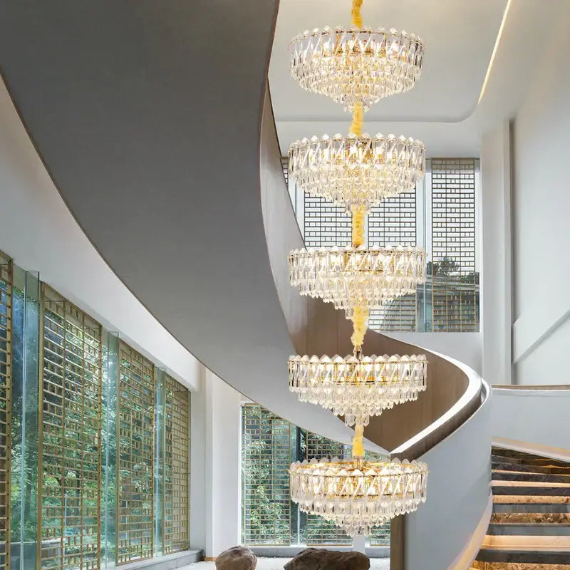 Decorbites crystal duplex chandelier gold multi-tiered crystal lighting hanging above spiral staircase