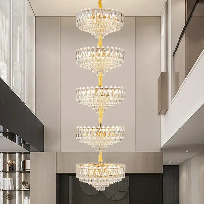 A multi-tiered decorbites crystal duplex chandelier with a golden frame and clear glass prisms for living room lighting