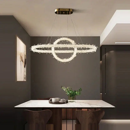 A modern decorbites crystal flower led chandelier with crystal-encrusted rings and a gold-toned ceiling mount
