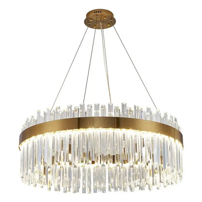 A modern decorbites crystal led chandelier with gold metal frame and cascading clear crystal prisms for dining room lighting