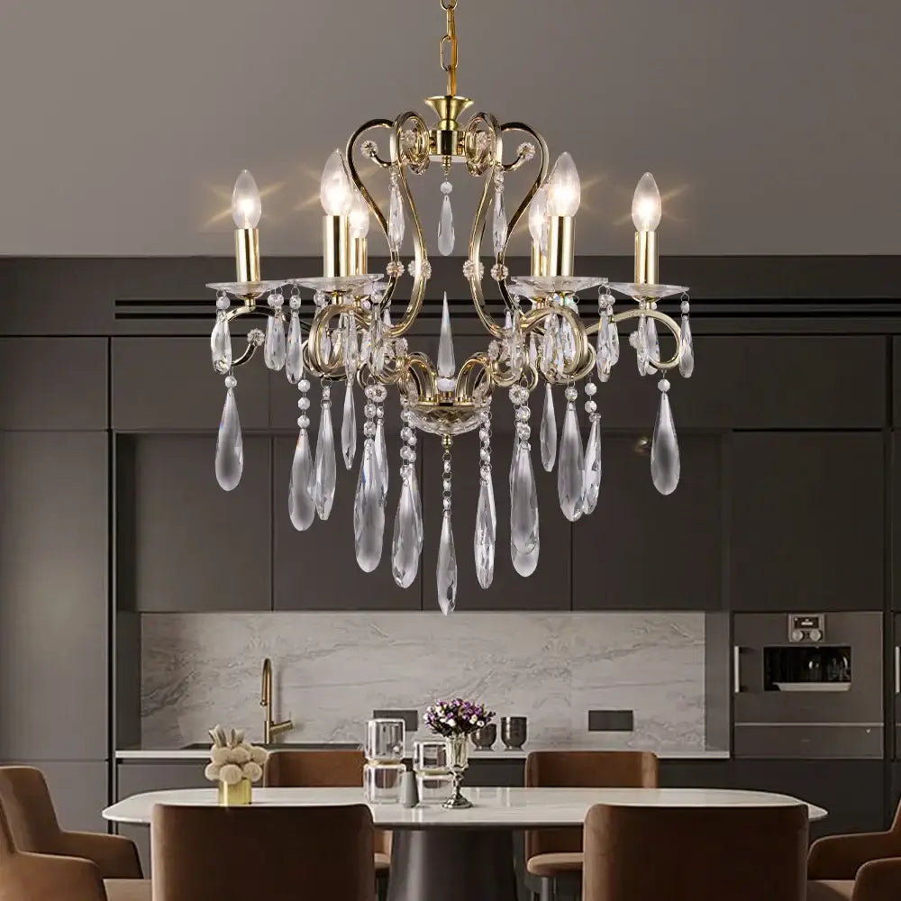 A luxurious gold-toned decorbites crystal led chandelier with dangling crystal teardrops and clear glass prisms