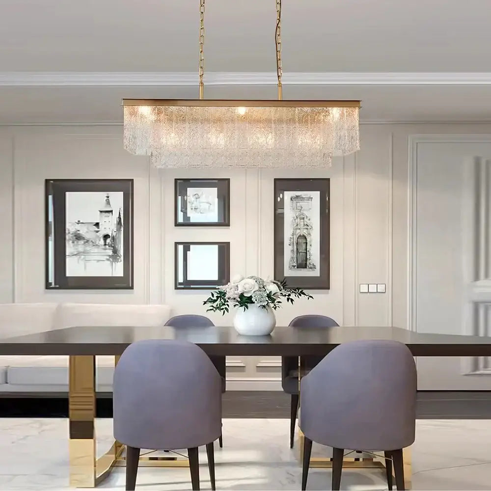 A rectangular gold-toned decorbites crystal led chandelier with cascading glass elements for dining room lighting