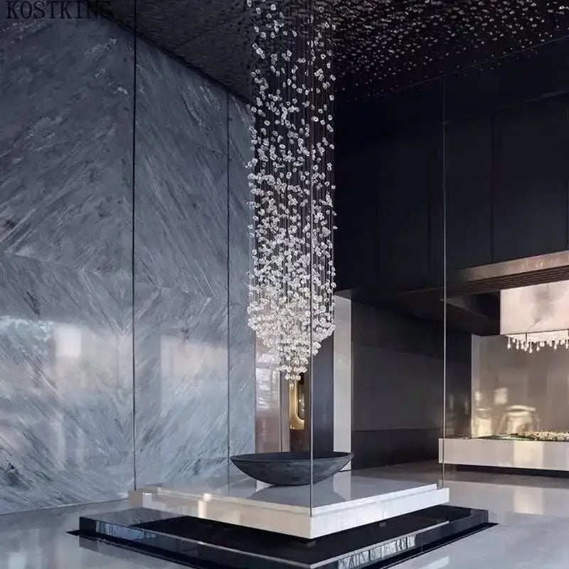 A cascading decorbites crystal led chandelier with clear faceted glass elements for luxury staircase lighting