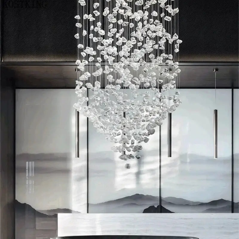 A modern decorbites crystal led chandelier with cascading clear glass pieces and metallic wires for luxury staircase lighting