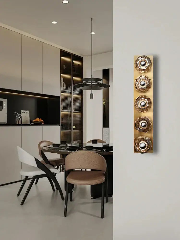Gold-toned modern luxury crystal led wall sconce with four circular flower-like decorbites crystal led elements for bedroom decor