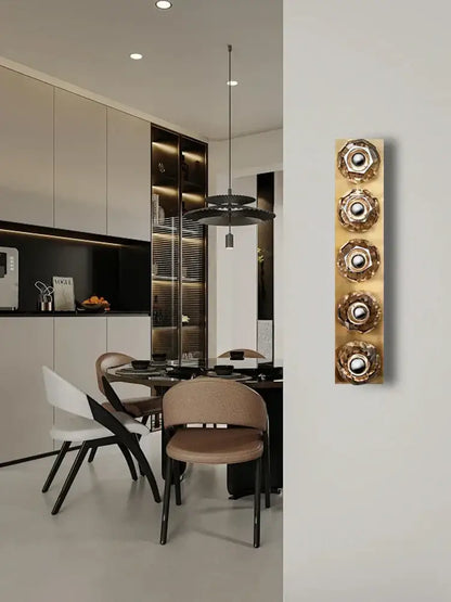Gold-toned modern luxury crystal led wall sconce with four circular flower-like decorbites crystal led elements for bedroom decor