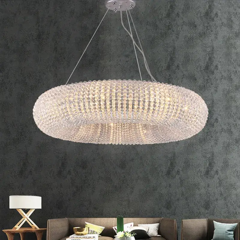 A modern crystal loft chandelier with a silver-toned ring of clear crystal beads for elegant living room decorbites lighting