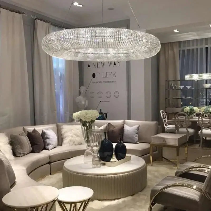 A large silver crystal loft chandelier with sparkling crystals and LED lights hangs in a modern living room decorbites crystal loft
